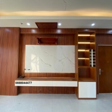 Thiết Kế Phòng Khách Đẳng Cấp Với Hệ Tủ Tivi & Vách Trang Trí Gỗ Nhựa Giả Vân Gỗ Kết Hợp Ốp Đá PVC Vân Mây
